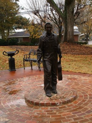 Bronze statue of Elvis in his home town, Tupelo, Mississippi, USA on a rainy day.
