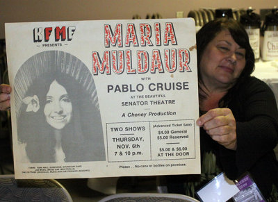 Local fan shows off a poster from a mid-'70s Maria Muldaur/Pablo Cruise concert in Chico, CA