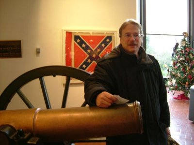 Don by cannon and old flag in museum