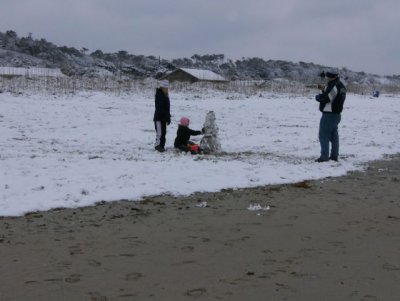 Making a snowman on the beach!