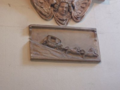 A stage coach as part of a memorial on the inside wall of the church