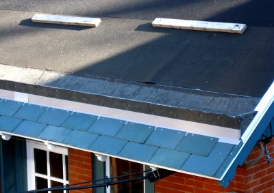First rows of roof tiles, and flashing below the pole gutter