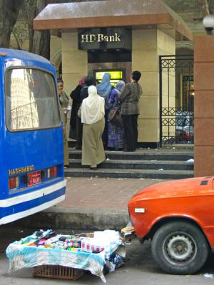 The strange combination of busy ATM and unattended street stand.