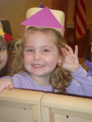 elisabeth smiling for us while she sits in the pew for her thanksgiving program