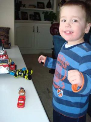 playing with his new cars