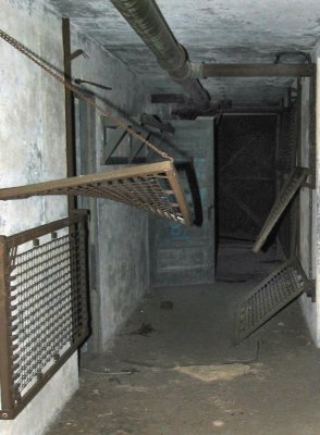 Prison-type wall bunks in Plotting-Spotting-Radion (PSR) room. Note suspension chain and S-hook on upper bunk.