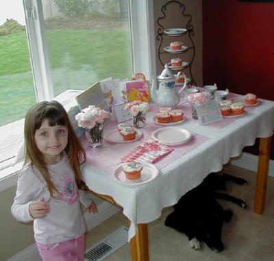 Isabella at the party table (Luna hiding underneath, waiting for Boingo to knock cupcakes off!)