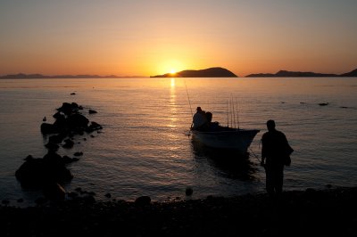 A fisherman goes out at dawn