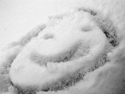He draw the smiley face in the snow with his finger...