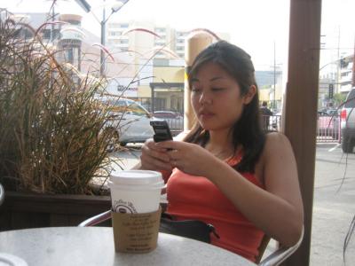 a 'rare' shot of tina texting. hah. (with the dope D500 and vanilla latte.. nonfat milk)