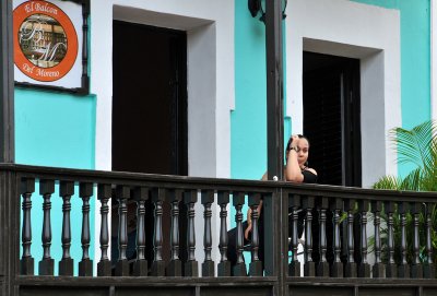 Woman looking down from restaurant's balcony
