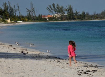 Young girl running around shoreline