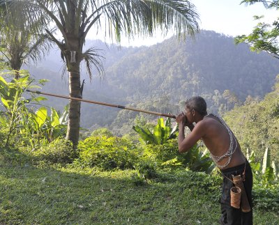 Orang Asli demonstrating the blowpipe.
