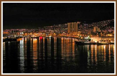 Honolulu harbor at night.