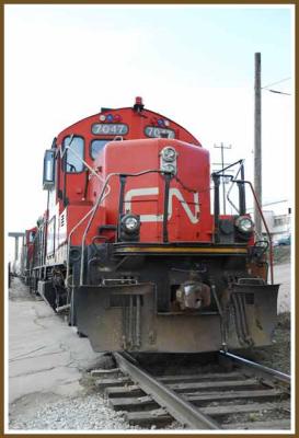 CN 7047 stopped at a crossing.