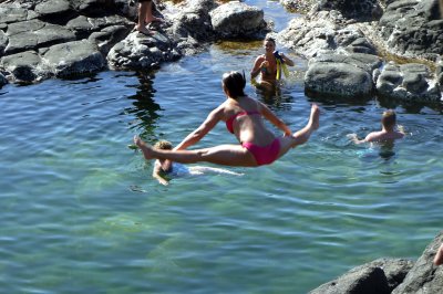 Jackie jumping into Queens Bath - Kauai