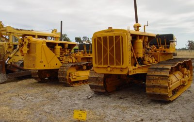 Two, 1H-series D8's from the WW2 era. The one to the left has had a fancy hardnose installed, so it could carry a cable blade without needing the overhead framework, that was usually used for blade lift mechanisms on Cats in this era. The one on the right is being erroneously described as a 1944, RD-8. The year of build may be correct, but the last RD-8 was built around August-Sept 1937. From that date on, they were merely known as the Caterpillar D8.