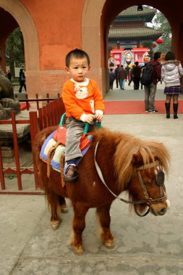 Ridding on a little horse