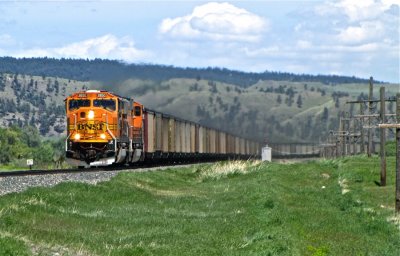 Coal dust wafting out of the freshly loaded hoppers behind BNSF 8850 at Greycliff, MT. 5/28/09