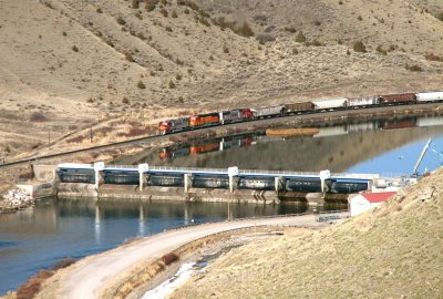 BNSF 8296 ant two other SD75Ms pull an old-school grain train past Toston Dam. 04/09/08