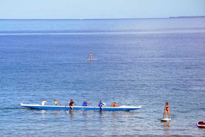 Another canoe crew and stand-up paddlers