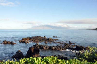 A volcanic reef points to West Maui