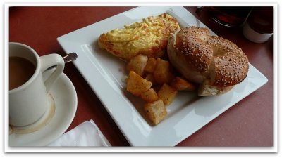 feta and tomato omelet, home fries and a sesame seed bagel