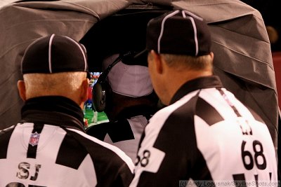NFL officials huddle to review a replay