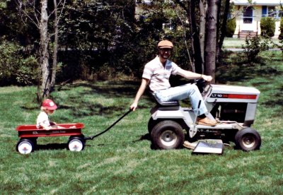 Giving Dan a ride while mowing - 1982
