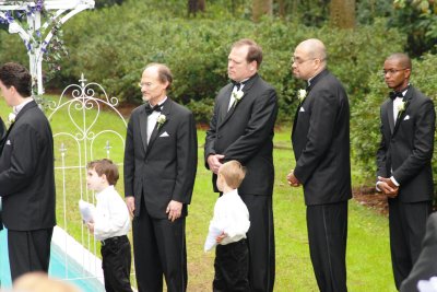 The groomsmen and ring bearers look on