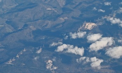 A line of wind turbines on the ridgeline