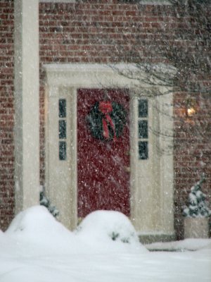 Festive doorway through the falling snow