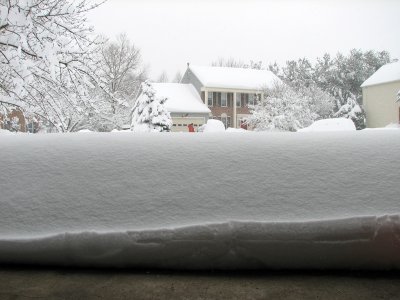 A pile of snow in front of the garage door