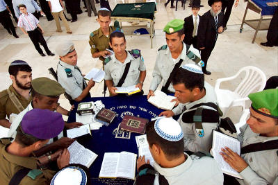 Soldiers praying by Western Wall