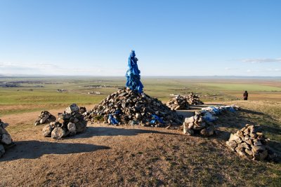 Ceremonial rock piles, some with horse skulls, overlooking Kharakhorum.  The walled Erdene Zuu Monestary is visible in the background.