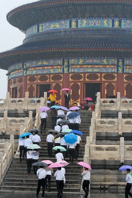Colorful umbrellas ascending the steps of the Temple of Prayer for Good Harvest