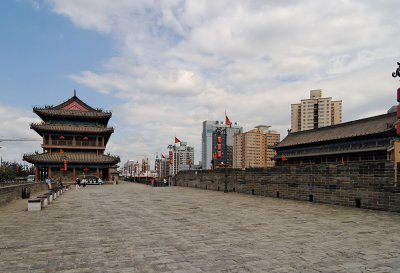 The Wall dates back to the Ming Dynasty, and modern skyscrapers are visible from the top of the wall.