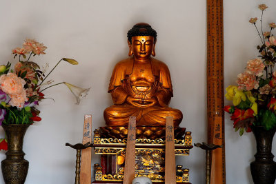 Buddha statue.  Note swastika-like symbol, which is a symbol of peace.