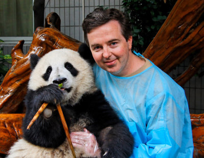 Chris with panda cub at Chengdu