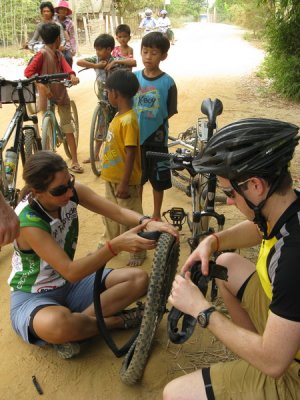 Fixing a flat, with lots of interested kids