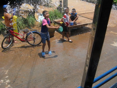 Kids on the street throwing water