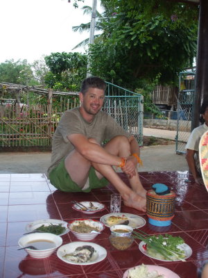 Eating on the front 'porch', which serves as dining table, social gathering point, work space, everything.