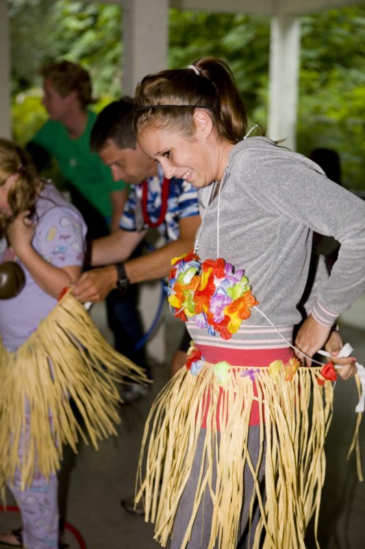 Karissa putting on the grass skirt