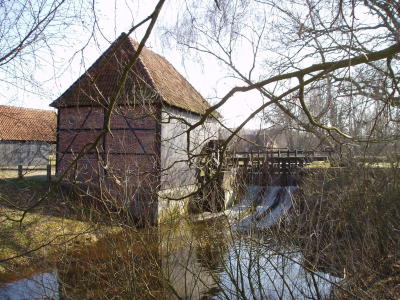 Watermill behind trees