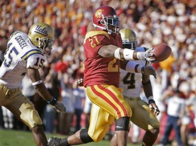 LenDale White rushes for 19 yards and a touchdown against Marcus Cassel and Jarrad Page in the second quarter.jpg