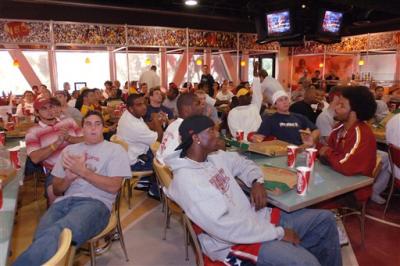 Southern California football players gather to watch a broadcast of Bowl Championship Series rankings at the USC campus.jpg