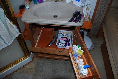 CUSTOM SHELVING WAS ALSO CONSTRUCTED  BELOW THE SINK IN THE BEDROOM AND KITCHEN