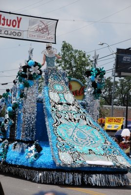 THE TRAINS ON THE GOWNS OF THE QUEENS OF FIESTA ARE SO LONG AND WIDE THAT THEY FORM THE BACK OF SOME FLOATS