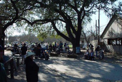 MOTORCYCLE GROUPS PULL IN AND OUT OF LUCKENBACH ON AN HOURLY BASIS