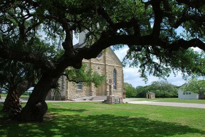 ST MARY'S OF PRAHA IS A BEAUTIFUL STONE CHUCH SET BETWEEN HUGE TEXAS LIVE OAKS